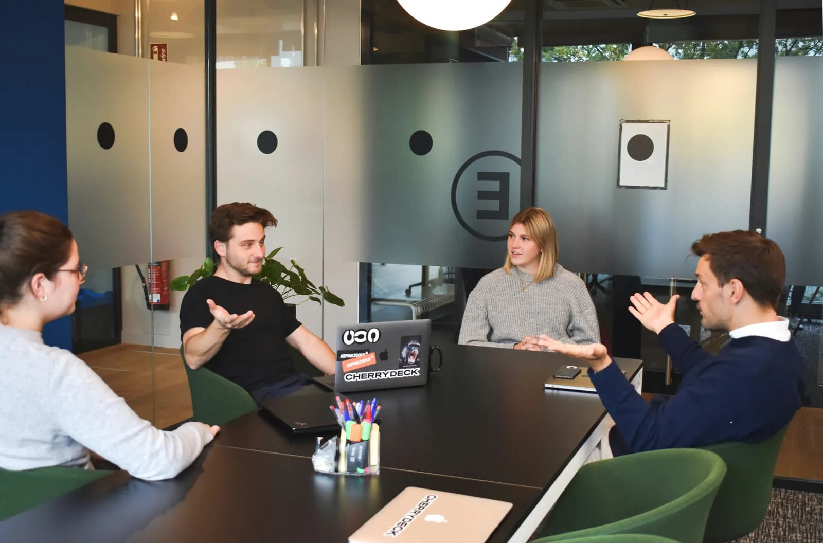 A small team discussing a project around a meeting table